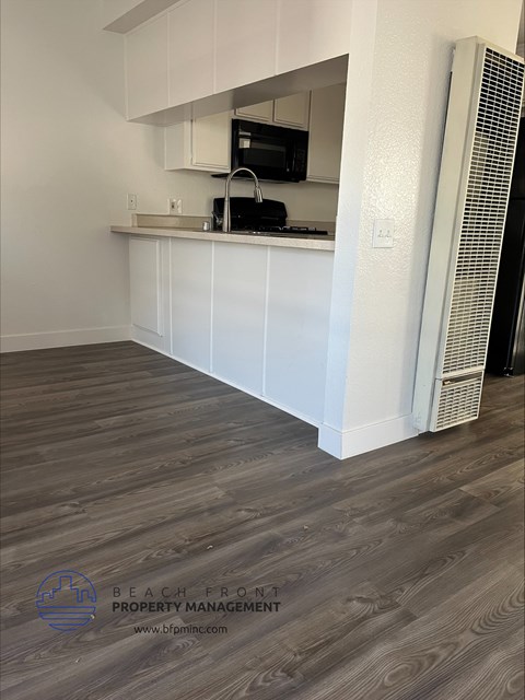 a view of a kitchen with a refrigerator and a counter